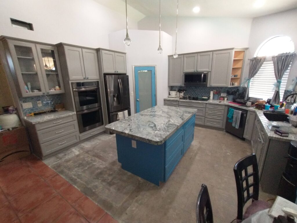 Kitchen Remodel with Blue Cabinet Island and Gray Marble Countertops